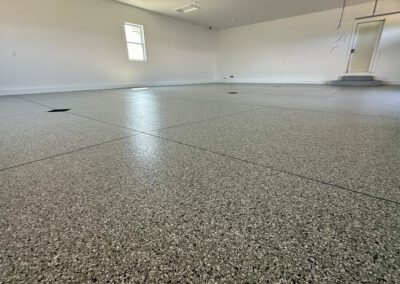 A spacious garage floor featuring a large, smooth area of concrete, ideal for parking or storage purposes