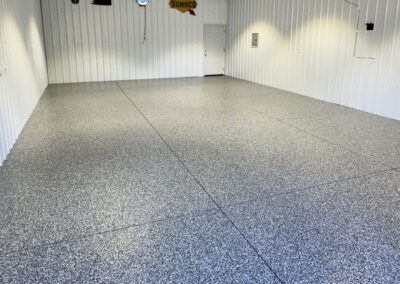 A large interior space with a floor made of gravel, providing a unique and textured surface throughout the room