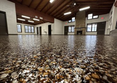 Epoxy flooring in a spacious room filled with natural light from numerous large windows