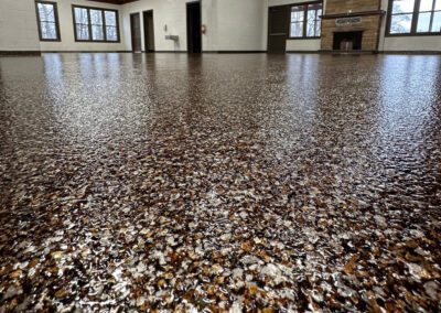 A spacious room featuring a vast floor entirely covered in gravel, creating a unique and textured environment