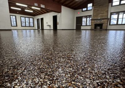 A spacious room featuring a vast floor entirely covered in gravel, creating a unique and textured environment