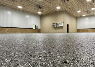 An expansive room with a large gravel-covered floor, offering a distinctive and rustic aesthetic